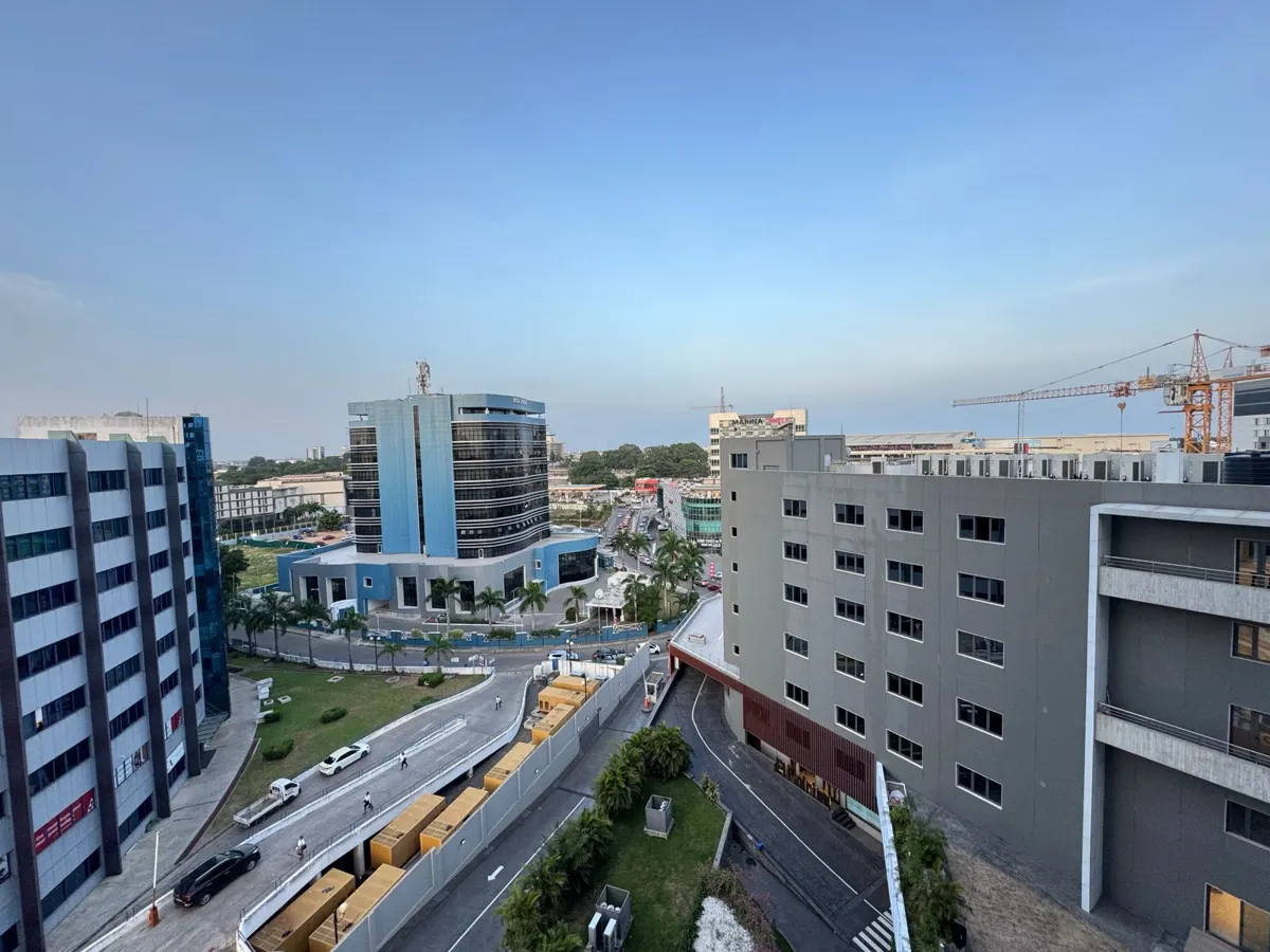 Modern office buildings and roads in Accra, Ghana, under a clear sky