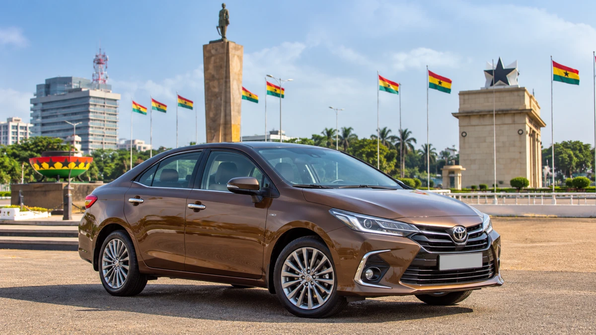 A bronze GoZi rental sedan parked at Black Star Square in Accra